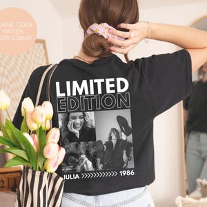 May include: Black t-shirt with the words "LIMITED EDITION" in white block letters. Below the text are three black and white photos. The name "JULIA" and the year "1986" are printed below the photos.