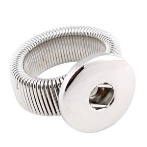 May include: A silver adjustable ring with a snap button closure. The ring is made of a coiled metal band.