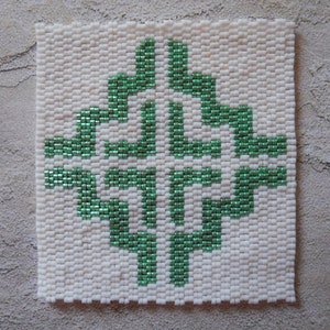 May include: A square beaded design with a green geometric pattern on a white background.