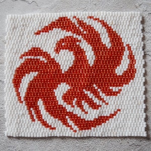 May include: A square-shaped beaded artwork featuring a stylized orange phoenix design on a white background.