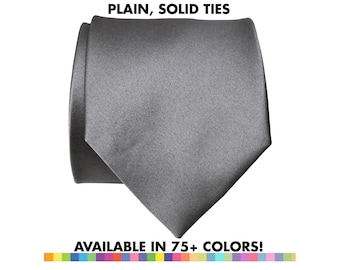 May include: A solid gray tie, neatly folded, against a white background. The tie is made of a smooth fabric and has a classic pointed end. Text at the top reads "PLAIN, SOLID TIES" and at the bottom "AVAILABLE IN 75+ COLORS!"