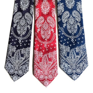 May include: Three silk ties with a paisley pattern. The ties are navy blue, red, and dark blue with a white paisley design.