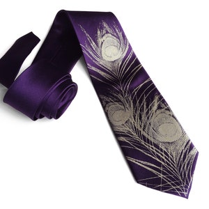 May include: A purple silk tie with a white peacock feather design.