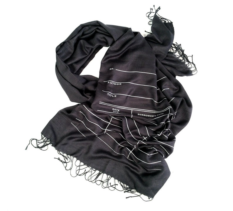 May include: Black scarf with white lines and text that reads "No. - Author - Title - Date Due - Borrower's Name".