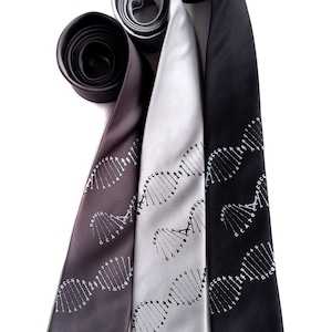 May include: Three silk ties featuring a DNA double helix pattern printed in white. The ties are black, grey, and silver.