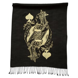 May include: Black scarf with a gold Queen of Spades design. The scarf has a fringe border.