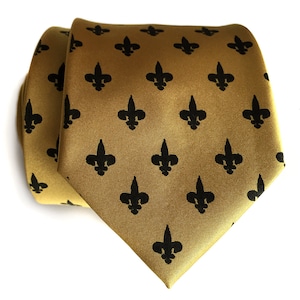 May include: A gold tie with a black fleur-de-lis pattern.