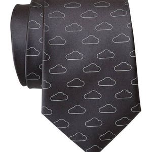 May include: A dark gray silk tie with a white cloud pattern.