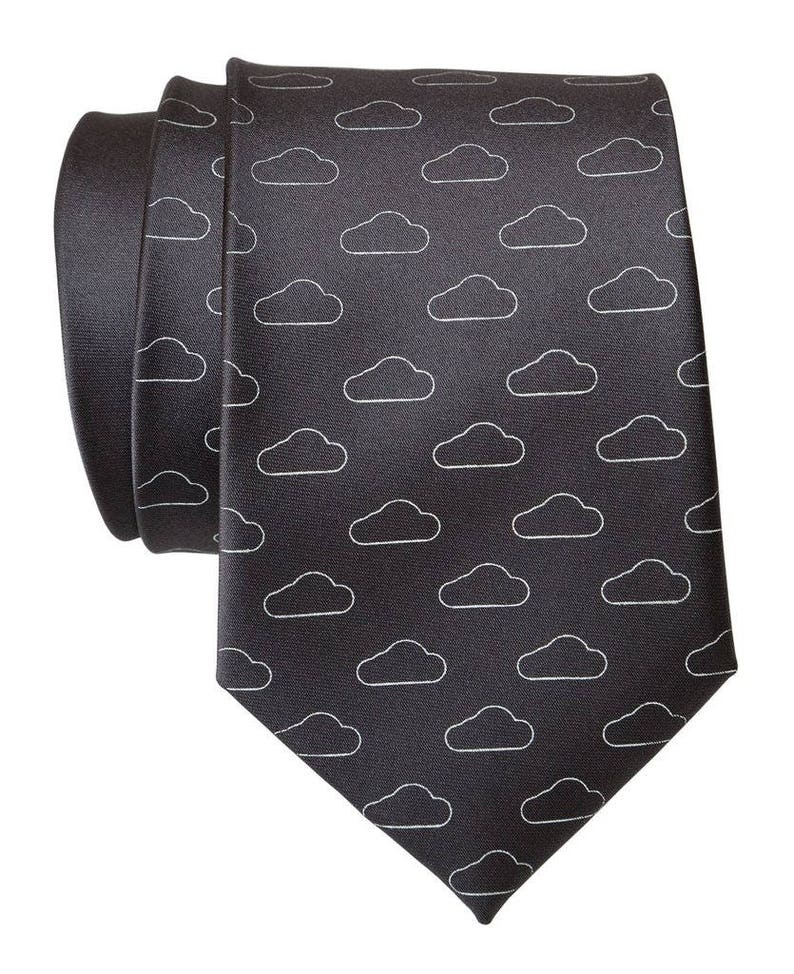 May include: A dark gray silk tie with a white cloud pattern.