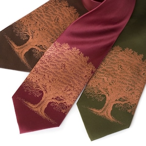 May include: Three silk neckties with a brown, burgundy, and olive green background. Each tie features a copper-colored tree design.