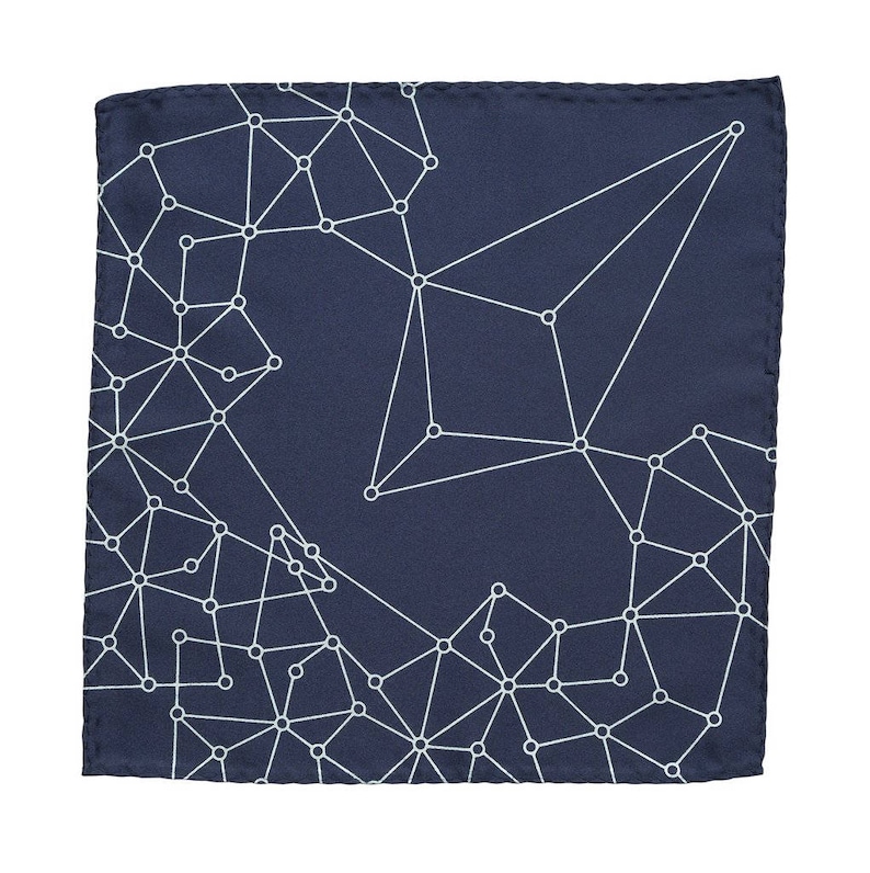 May include: A navy blue pocket square with a white geometric pattern of connected circles and lines.