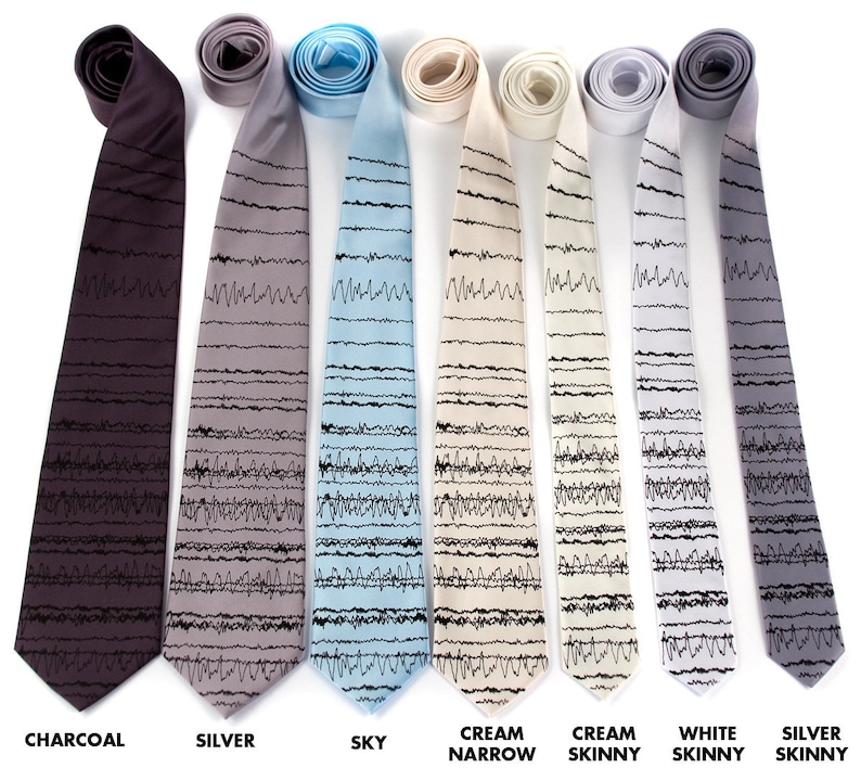 May include: Five silk ties with a black and white EKG pattern. The ties are in the colors charcoal, silver, sky blue, cream, and white.