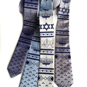 May include: Collection of patterned neckties in shades of blue and gray, featuring Hanukkah symbols like the Star of David, menorahs, and dreidels. The ties have a repeating pattern of hearts and geometric shapes.