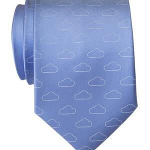May include: A blue silk tie with a white cloud pattern.