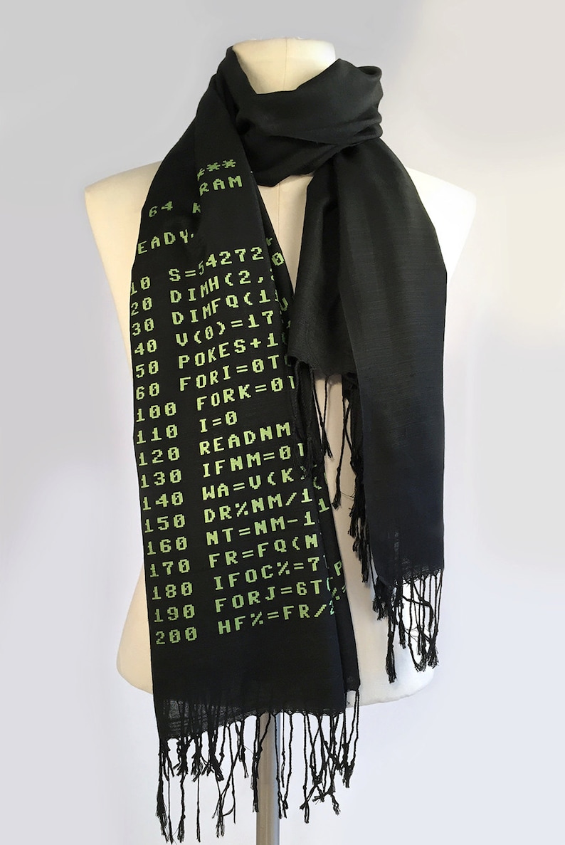 May include: A black scarf with green text printed on it. The text is a code snippet, including the words "READY", "RAM", "DIMH", "DIMFQC", "FORI", "FORK", "READNM", "IFNM", "WA", "DR%", "NT", "FR", "IFOC%", "FORJ", and "HF%".