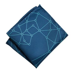 May include: A dark blue pocket square with a geometric pattern of light blue lines and circles.