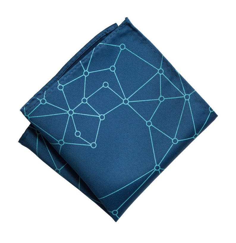 May include: A dark blue pocket square with a geometric pattern of light blue lines and circles.