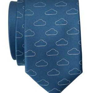 May include: A dark blue necktie with a white cloud pattern.
