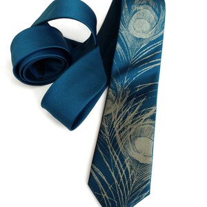 May include: A teal blue silk tie with a gold peacock feather pattern.