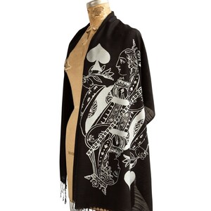 May include: Black silk scarf with a white print of the Queen of Spades playing card. The Queen is wearing a crown and holding a sword.