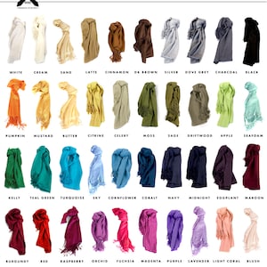 May include: A chart of 24 different colored soft viscose pashmina samples. Each sample is tied in a knot and has tassels on both ends. The colors are labeled with their names, such as white, cream, sand, latte, cinnamon, and more.