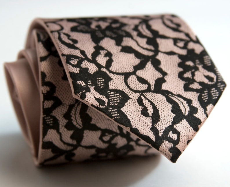 May include: A pink tie with a black lace pattern.