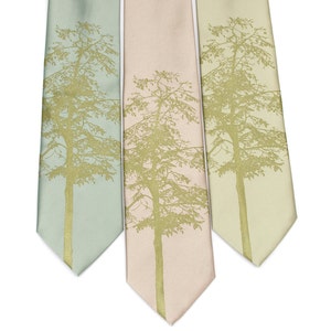 May include: Three silk neckties with a gold tree silhouette design. The ties are in shades of light blue, pink, and green.