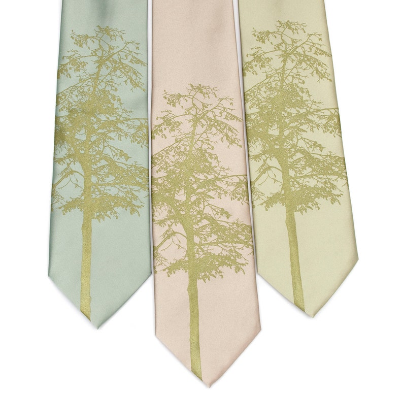 May include: Three silk neckties with a gold tree silhouette design. The ties are in shades of light blue, pink, and green.