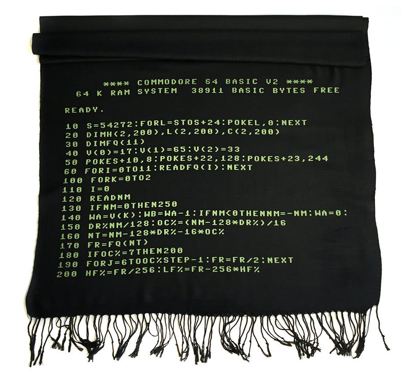 May include: A black and green scarf featuring a vintage Commodore 64 computer code design. The code is written in green text on a black background. The code includes the text "COMMODORE 64 BASIC U2" and "READY."