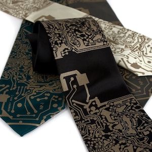 May include: Three silk ties with a circuit board pattern in gold on different colored backgrounds. The ties are green, black, and beige.