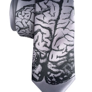 May include: A gray silk tie with a black and white anatomical brain print.