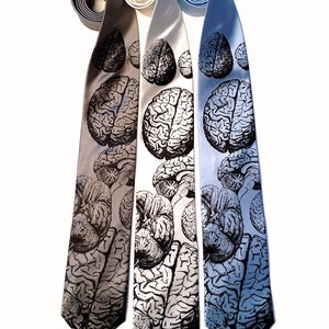 May include: Three silk ties with a black and white anatomical brain print. The ties are in shades of gray, light gray, and light blue.