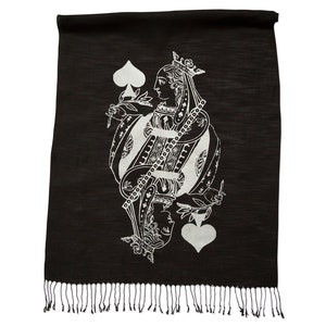 May include: Black silk scarf with a white print of the Queen of Spades playing card. The scarf has a fringe border.