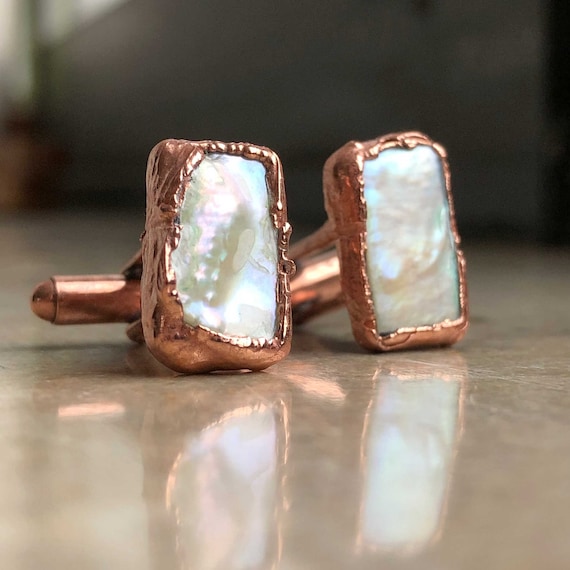 Electroformed copper cufflinks with real freshwater pearls — a genuinely artisan process that produces one-of-a-kind organic shapes no factory can replicate.