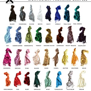 May include: A collection of 24 lightweight pashmina scarves in various colours, including black, white, teal, green, blue, red, pink, yellow, and brown. Each scarf is 74 inches by 28 inches with 3 tassels on both ends. The scarves are made of 100% viscose (modal - plant fibre) and are vegan friendly.