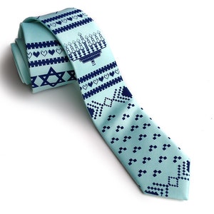 May include: A light blue necktie with a repeating pattern of navy blue menorahs, hearts, and Star of David symbols. The tie is made of a smooth fabric and is suitable for special occasions or everyday wear.