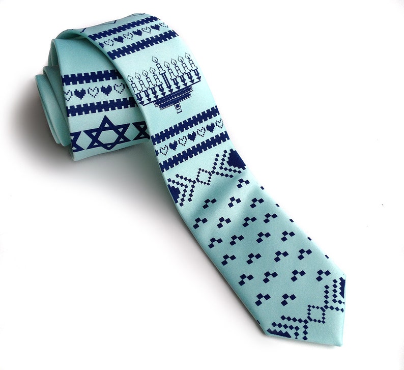 May include: A light blue necktie with a repeating pattern of navy blue menorahs, hearts, and Star of David symbols. The tie is made of a smooth fabric and is suitable for special occasions or everyday wear.