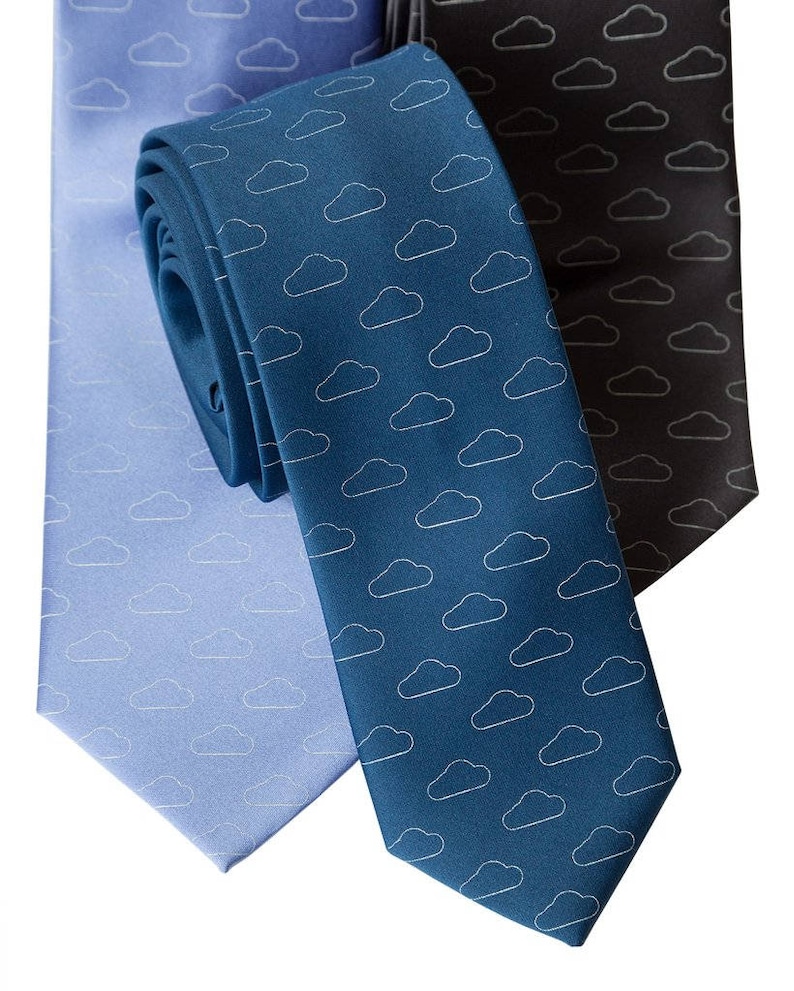May include: Three neckties with a cloud pattern. The ties are blue, light blue, and black.