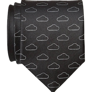 May include: A black necktie with a white cloud pattern.