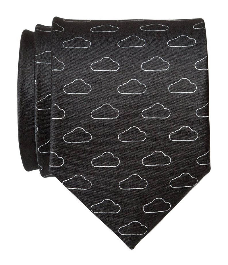 May include: A black necktie with a white cloud pattern.