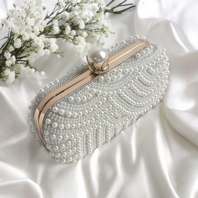 pearl beaded clutch bag on satin cloth and baby breath