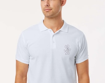 May include: A light blue polo shirt with a classic collar and short sleeves. The shirt features a small, embroidered Minnie Mouse design on the chest. The shirt is paired with a black belt.