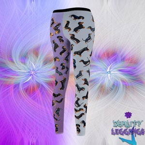 Back side view of Duality Leggings with dachshunds illustrations.
The left leg has lilac background, the right leg has grey background.