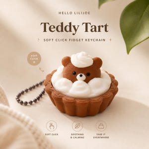 May include: A brown teddy bear-shaped keychain in a tart with white frosting. The keychain has a silver chain. The image includes the text "Teddy Tart" and "Soft Click Fidget Keychain", plus "Soft Click", "Soothing & Calming", and "Take it Everywhere".