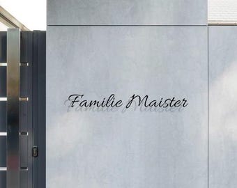 May include: A grey concrete wall with the text "Familie Maister" written in black cursive lettering.