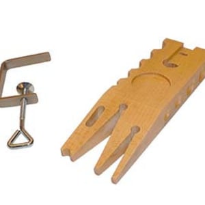 May include: A wooden ring mandrel with a metal clamp. The mandrel has a V-shaped opening and a textured surface. The clamp has a screw and a handle.