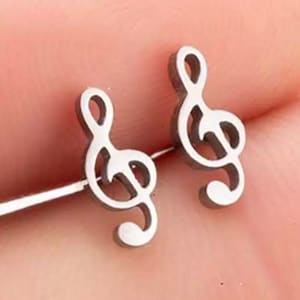 May include: A pair of silver tone stud earrings featuring a treble clef design.