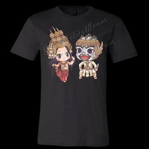 May include: Black t-shirt featuring a cartoon illustration of two figures in traditional Cambodian attire. The figures are adorned with ornate gold headdresses and detailed clothing. The text "Lotus Bloom" is visible on the shirt.