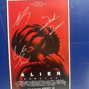 May include: A movie poster for "Alien: Romulus" with a red background. The poster features a creature's head and multiple signatures. The film's title is in large white letters. The text "ONLY IN THEATERS AUGUST 16" is at the bottom.