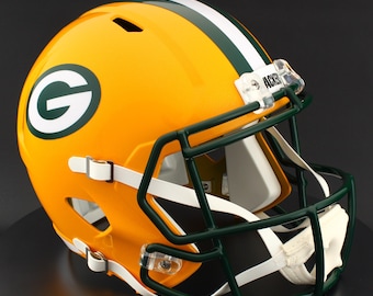 May include: A yellow and green football helmet with a green facemask and white straps. The helmet features a large white and green "G" logo on the side and a white stripe down the center.